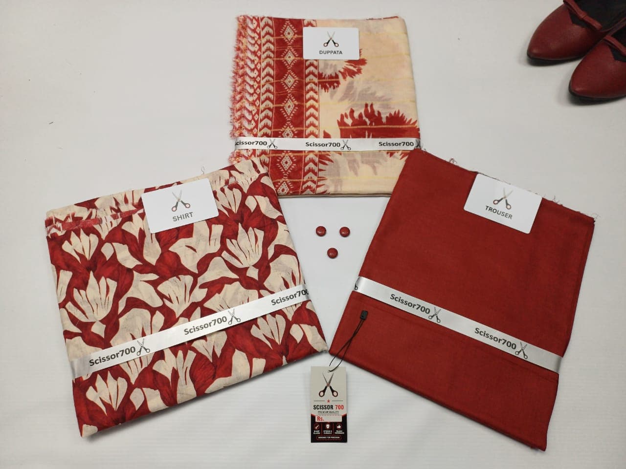 Crimson Bloom three piece unstitched lawn suit laid out with shirt, dupatta and trouser